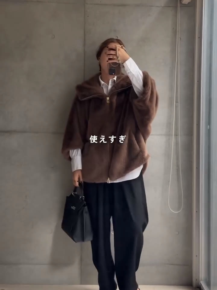 VOUTEのファーコートに白シャツと黒のパンツ、黒のバッグを合わせた全身
