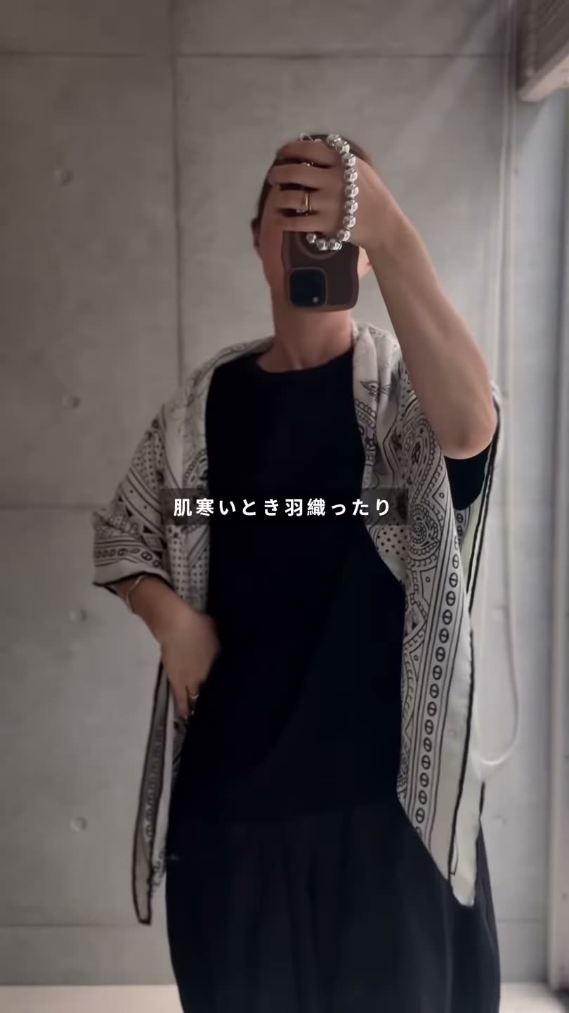 黒のトップスの上から大判ストールを羽織ったところ